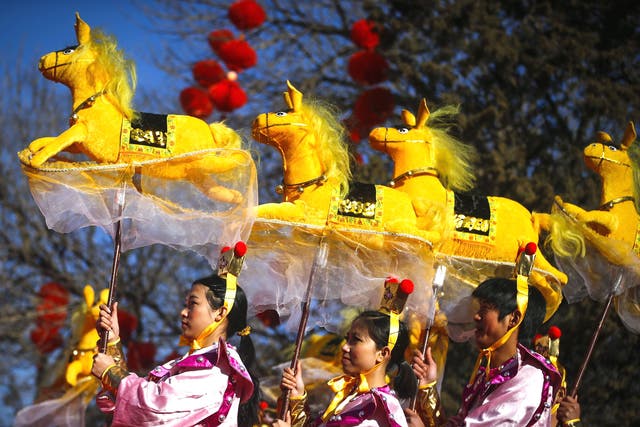 Performers do the horse dance on the evening of the Lunar New Year, or Spring Festival, at a park fair in Beijing