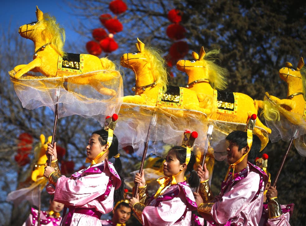 Performers do the horse dance on the evening of the Lunar New Year, or Spring Festival, at a park fair in Beijing