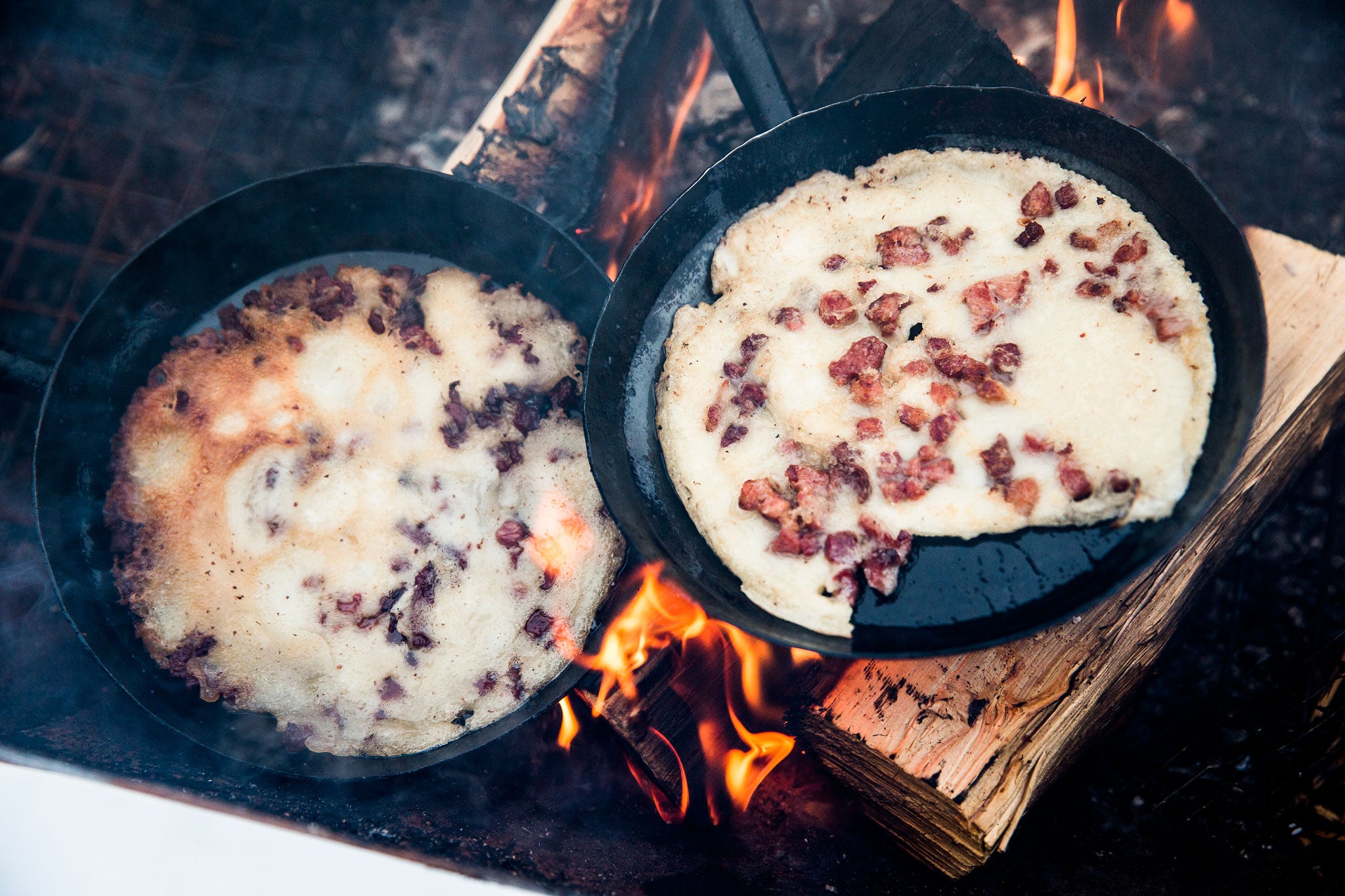 Kolbulle - a salty bacon pancake - cooks on the fire