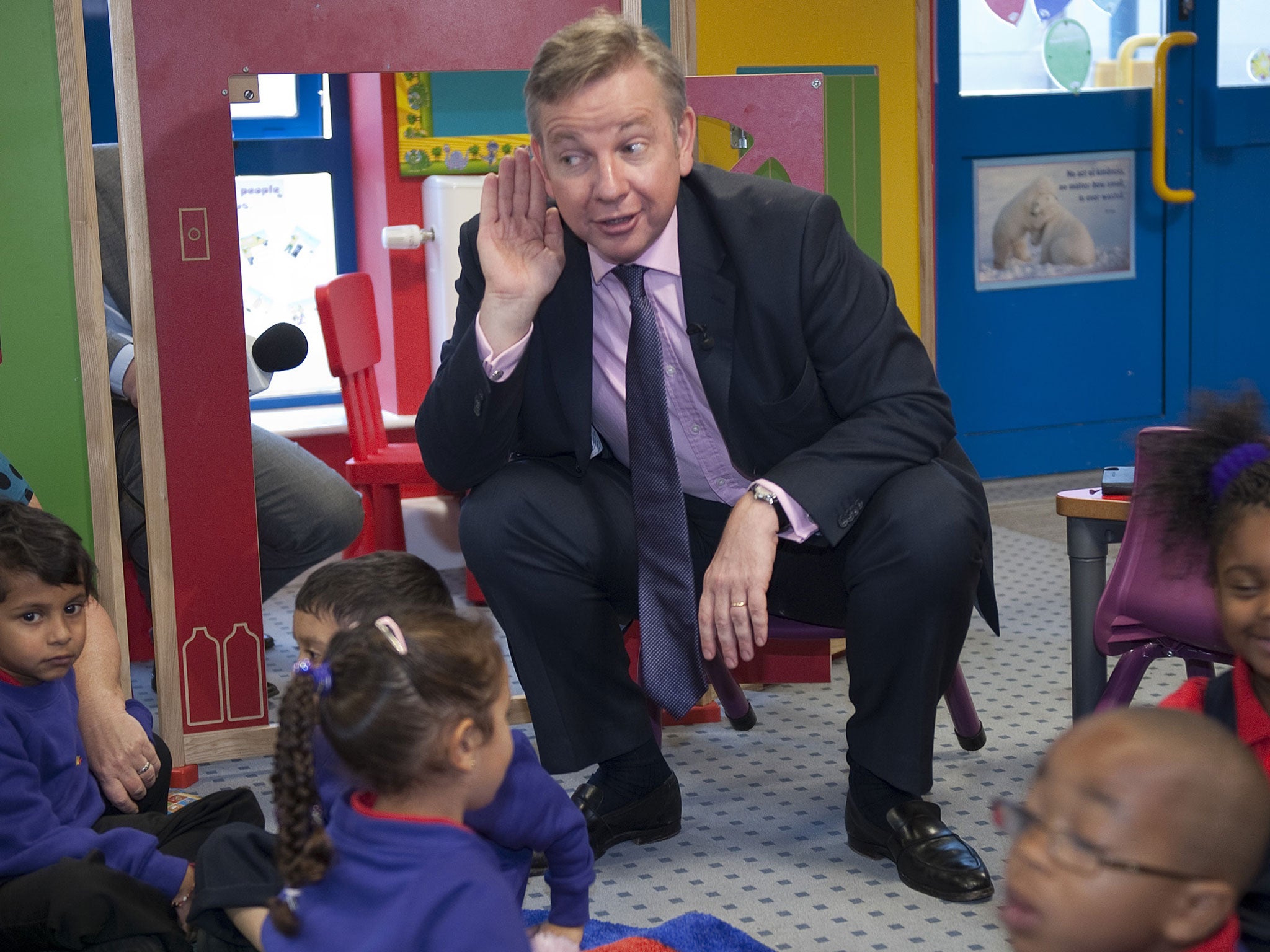 Michael Gove visits a primary school in 2011; four-year-olds will take tests upon entering the reception year