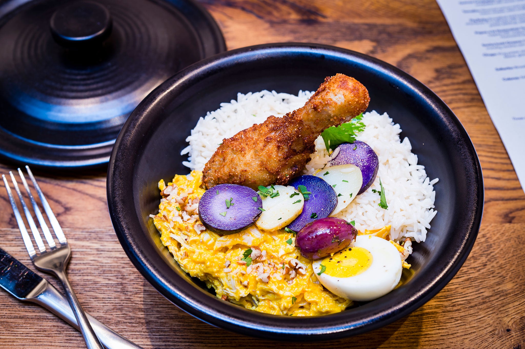 Traditional: Andina's aji de gallina is a chicken casserole that comes in a mildly spiced creamy sauce, and is served with rice, Peru's famous purple potatoes, and a quinoa-coated drumstick