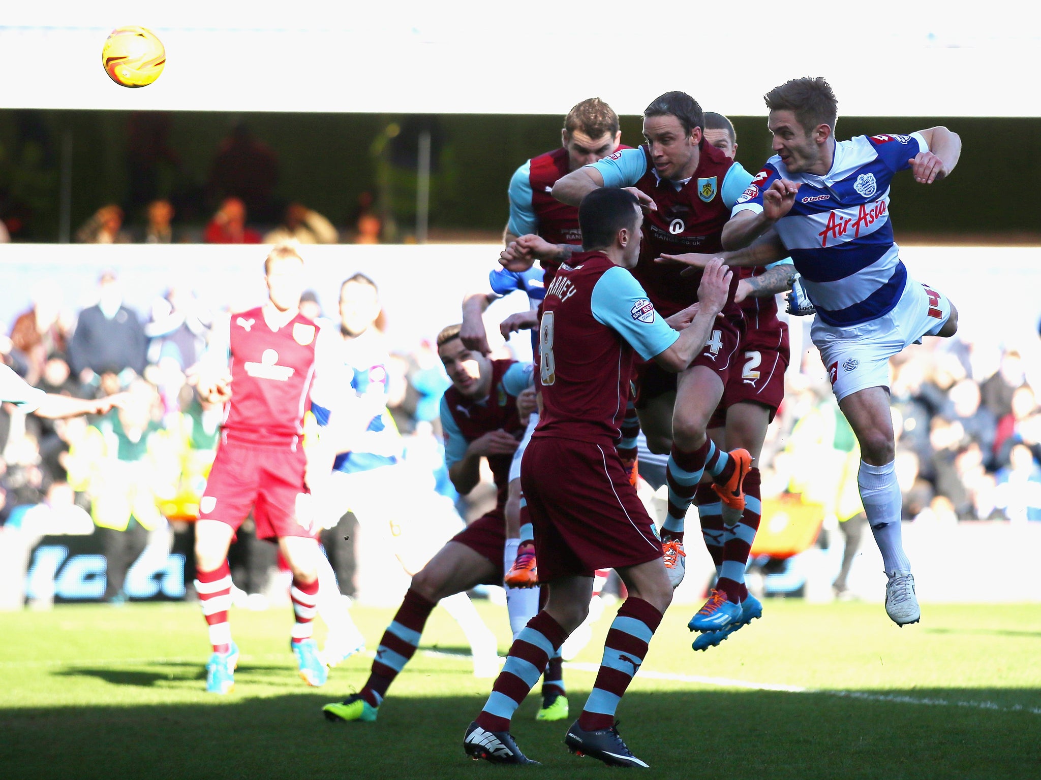 Queens Park Rangers and Burnley players compete for the ball during their Championship clash at Loftus Road