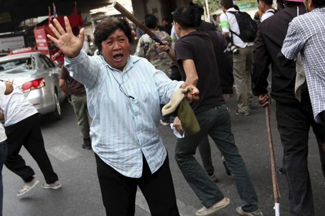 Protesters clash yesterday at a polling station in Bangkok’s Lak Si district