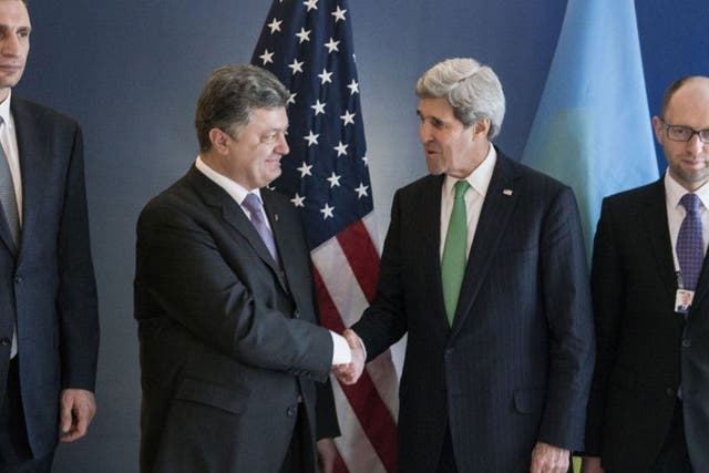 Ukrainian politician Petro Poroshenko (left) with John Kerry yesterday