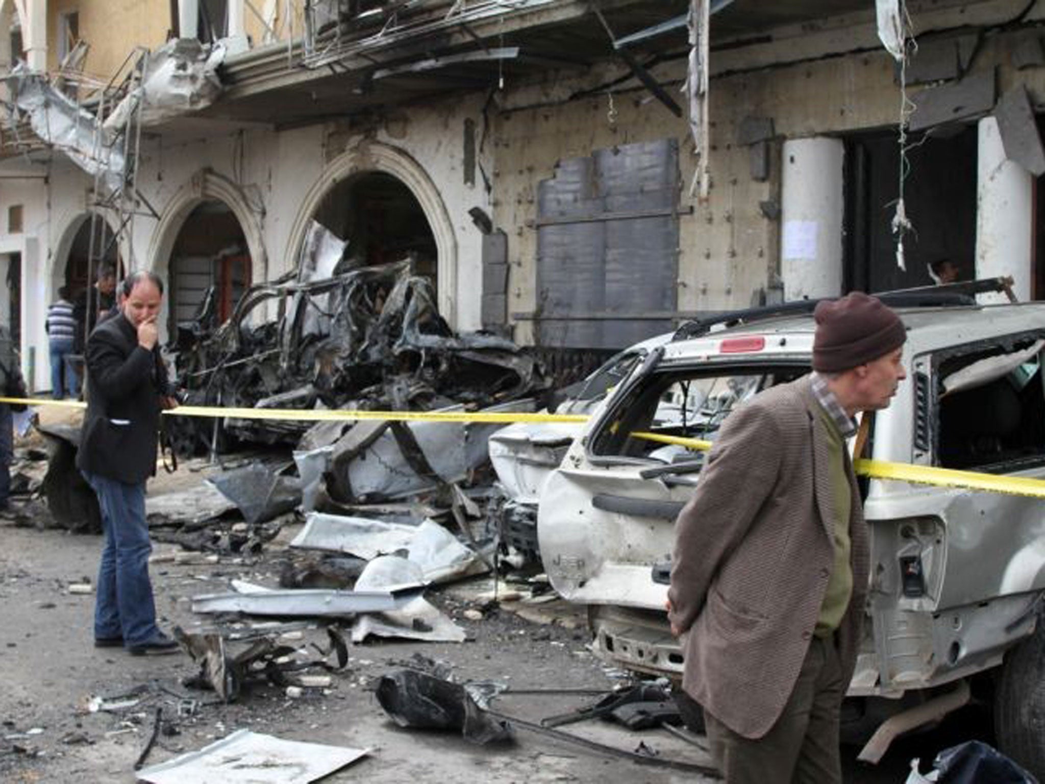 A new threat: Residents inspect the wreckage of a car bomb in Hermel last month