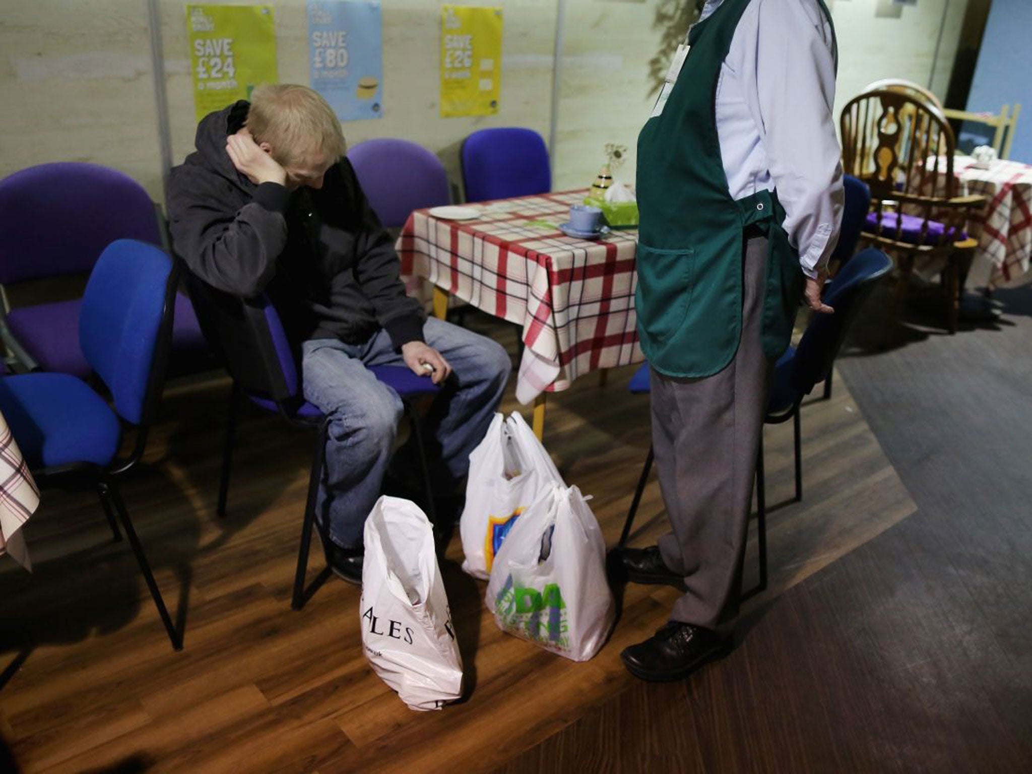 An overwhelmed man collects food from his local food bank