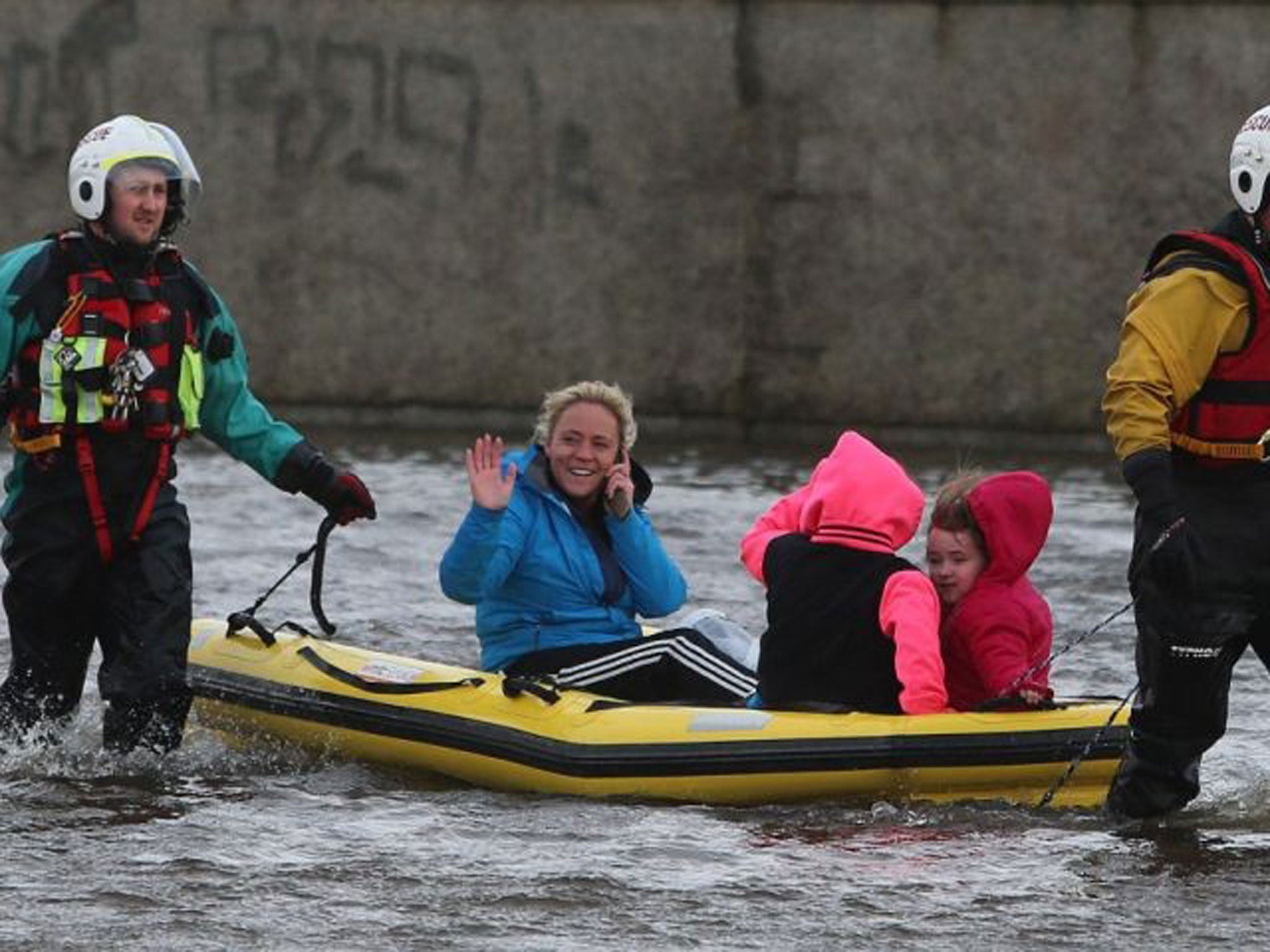 A woman and her children are transported after a flash flood