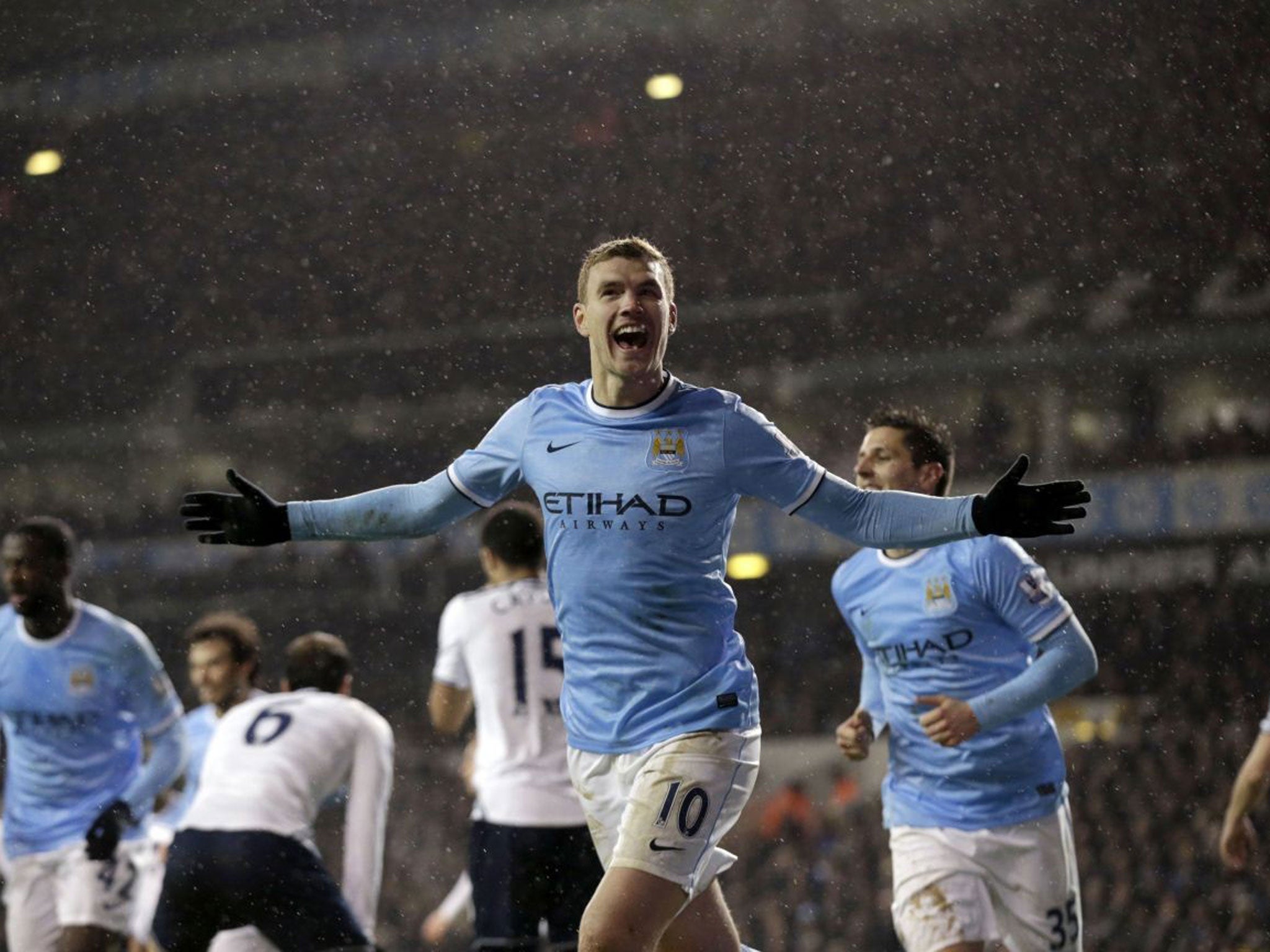 City slicker: Edin Dzeko celebrates scoring City’s third goal against Tottenham