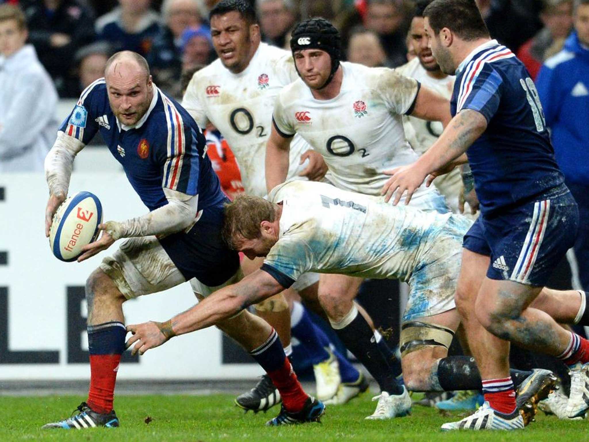 French player Antoine Burban fights for the ball against English player Chris Robshaw