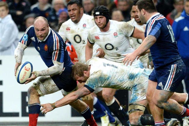 French player Antoine Burban fights for the ball against English player Chris Robshaw