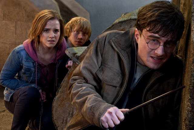 Daniel Radcliffe playing Harry Potter, alongside Emma Watson and Rupert Grint