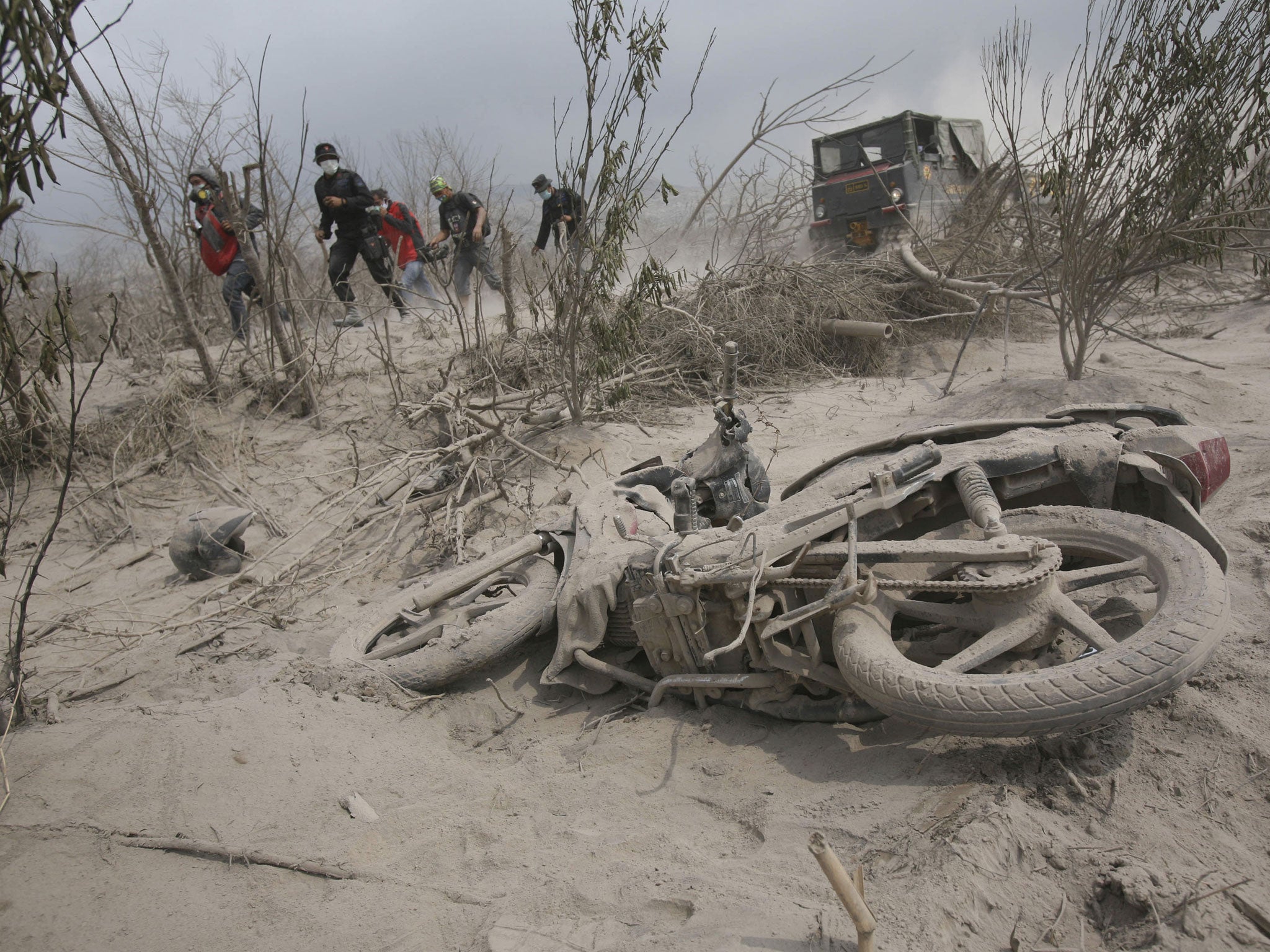 Rescuers search victims of the eruption of Mount Sinabung in February 2014