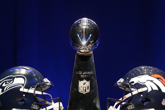 The Vince Lombardi Trophy and helmets for the Denver Broncos(R) and the Seattle Seahawks