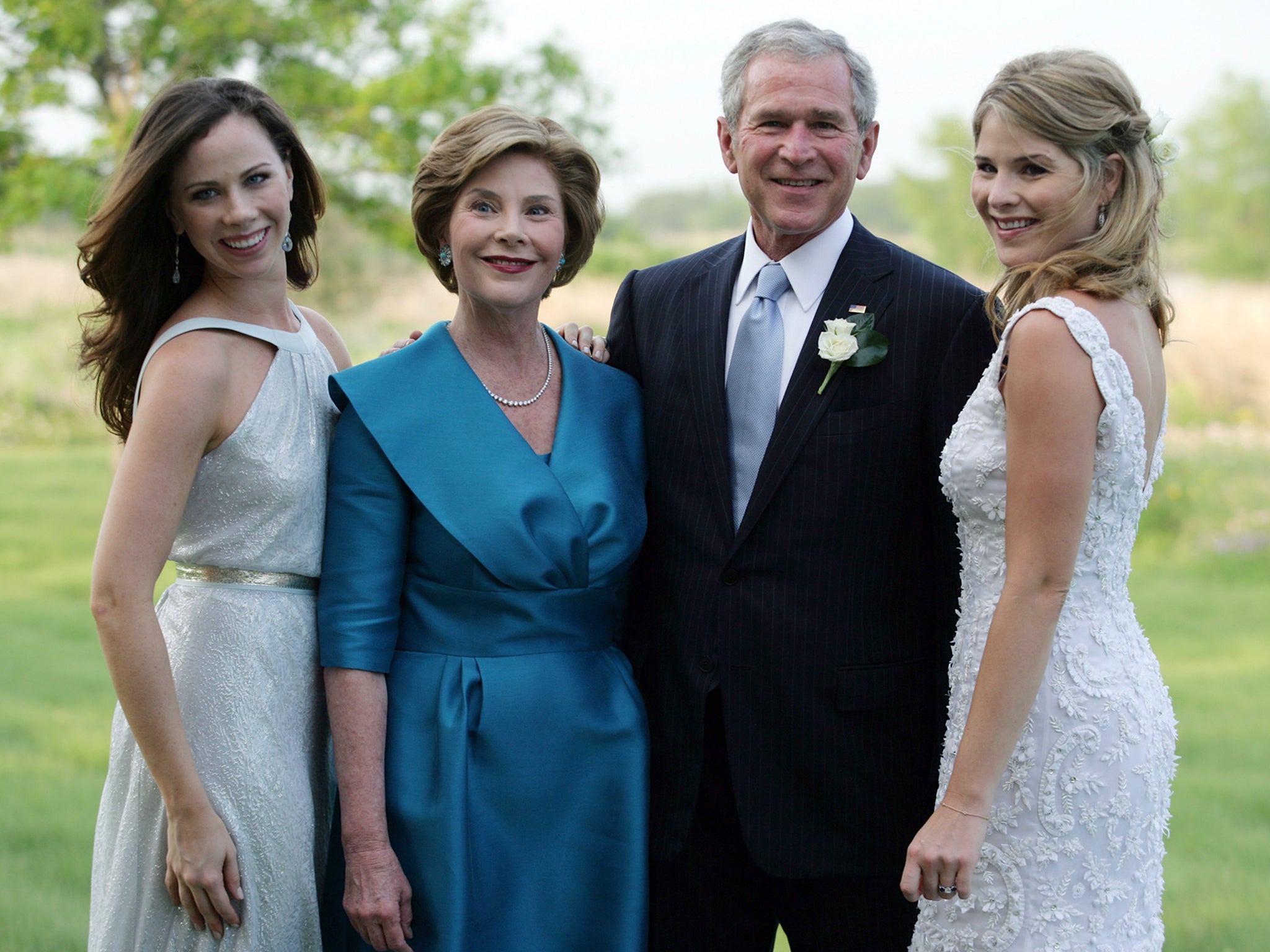 President George W. Bush and his wife Laura Bush pose with twin daughters Barbara (L) and Jenna (R) on Jenna Bush's wedding day
