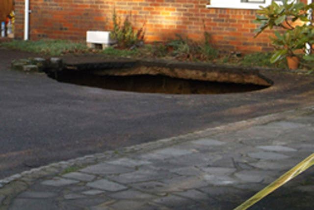 A 30ft deep sinkhole which has opened up in the driveway of a house in High Wycombe