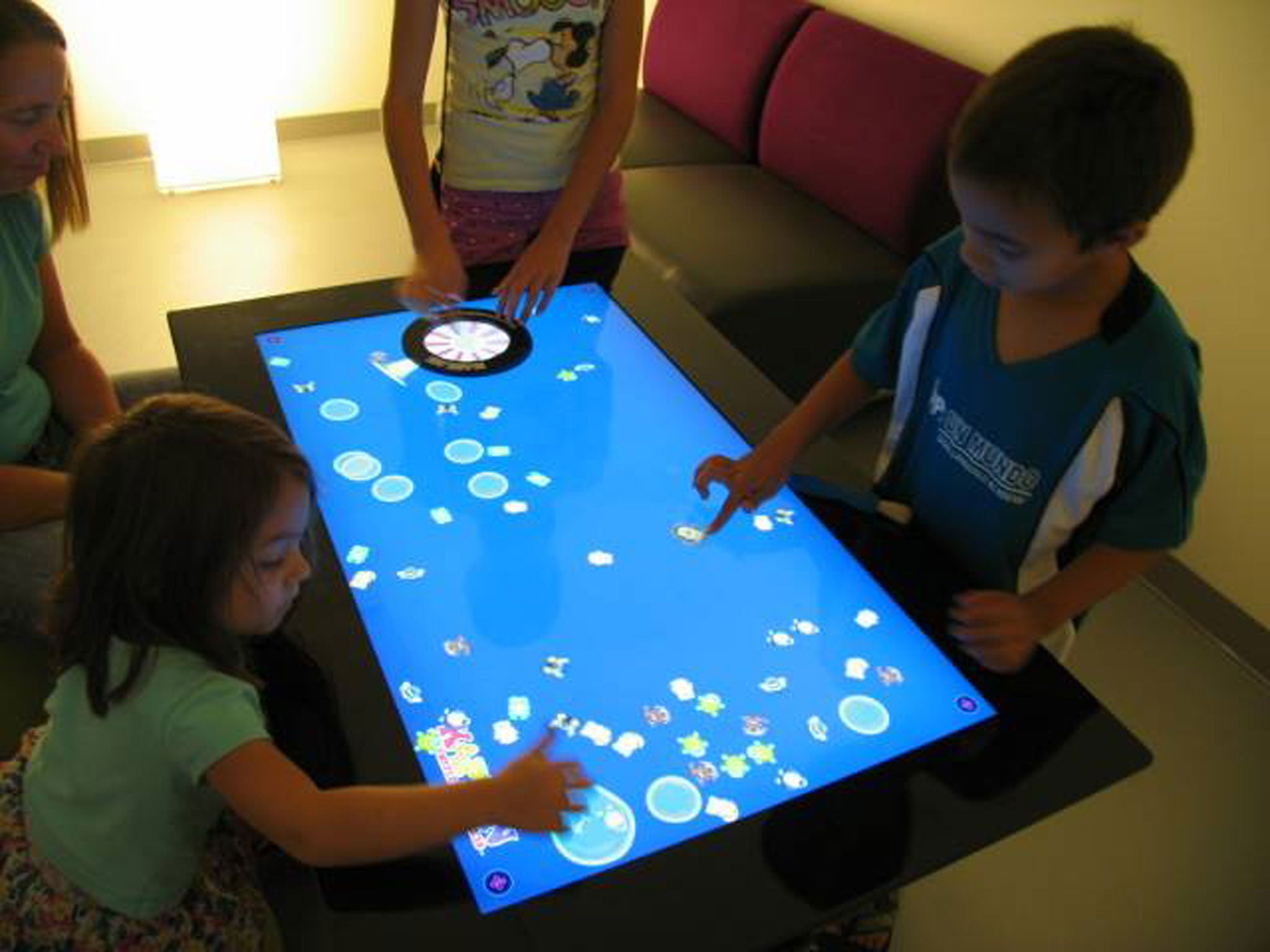 Children play on a tablet at the Bexar County Bibliotech