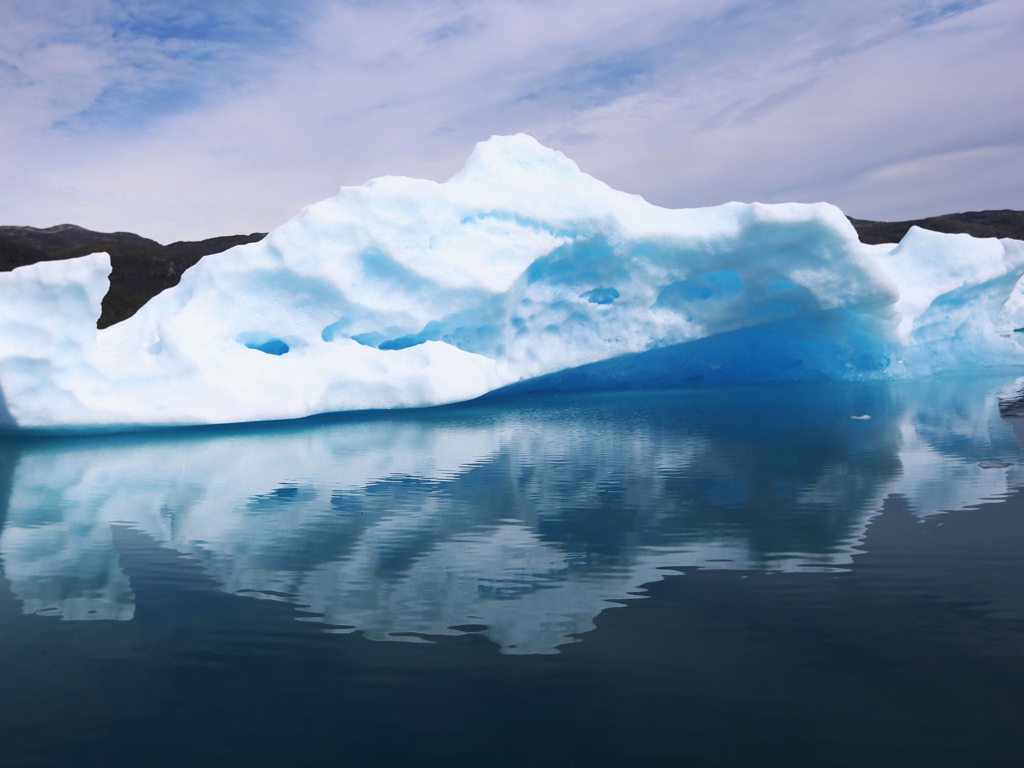 Calved icebergs from the nearby Twin Glaciers are seen floating on the water on 30 July, 2013 in Qaqortoq, Greenland. Meanwhile, the Jakobshavn Glacier in the south-west is moving faster than ever.