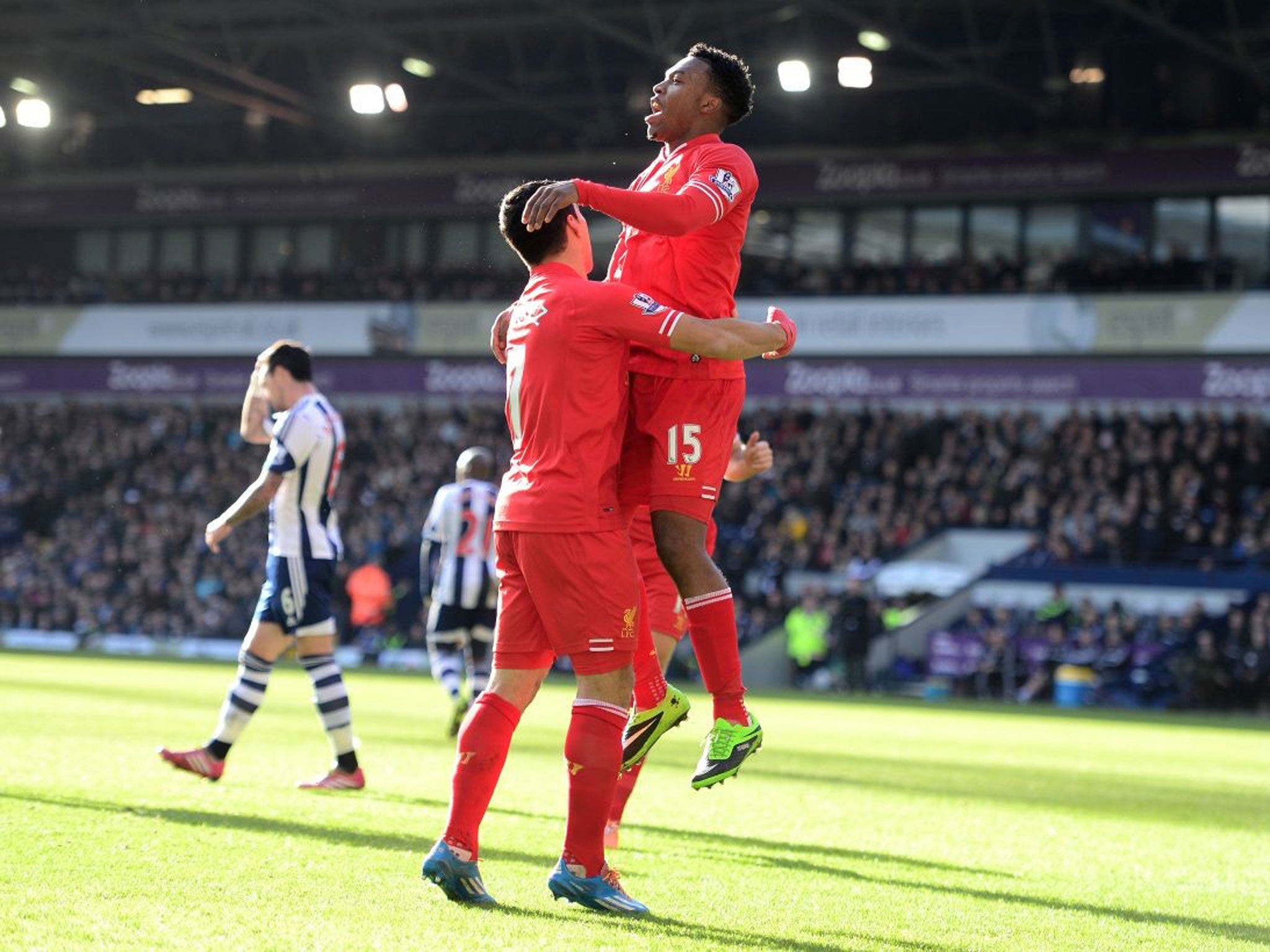 Daniel Sturridge (R) of Liverpool is congratulated by teammate Luis Suarez of Liverpool after scoring the opening goal in a match against West Bromich Albion