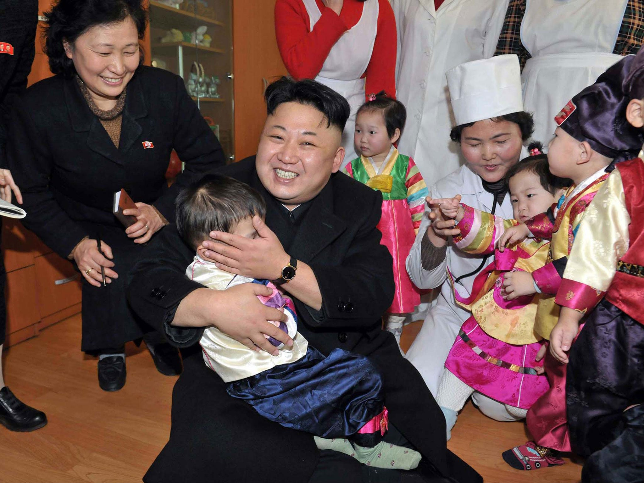This undated picture released by North Korea's official Korean Central News Agency on February 4, 2014 shows North Korean leader Kim Jong-Un visiting a baby home and orphanage in Pyongyang.