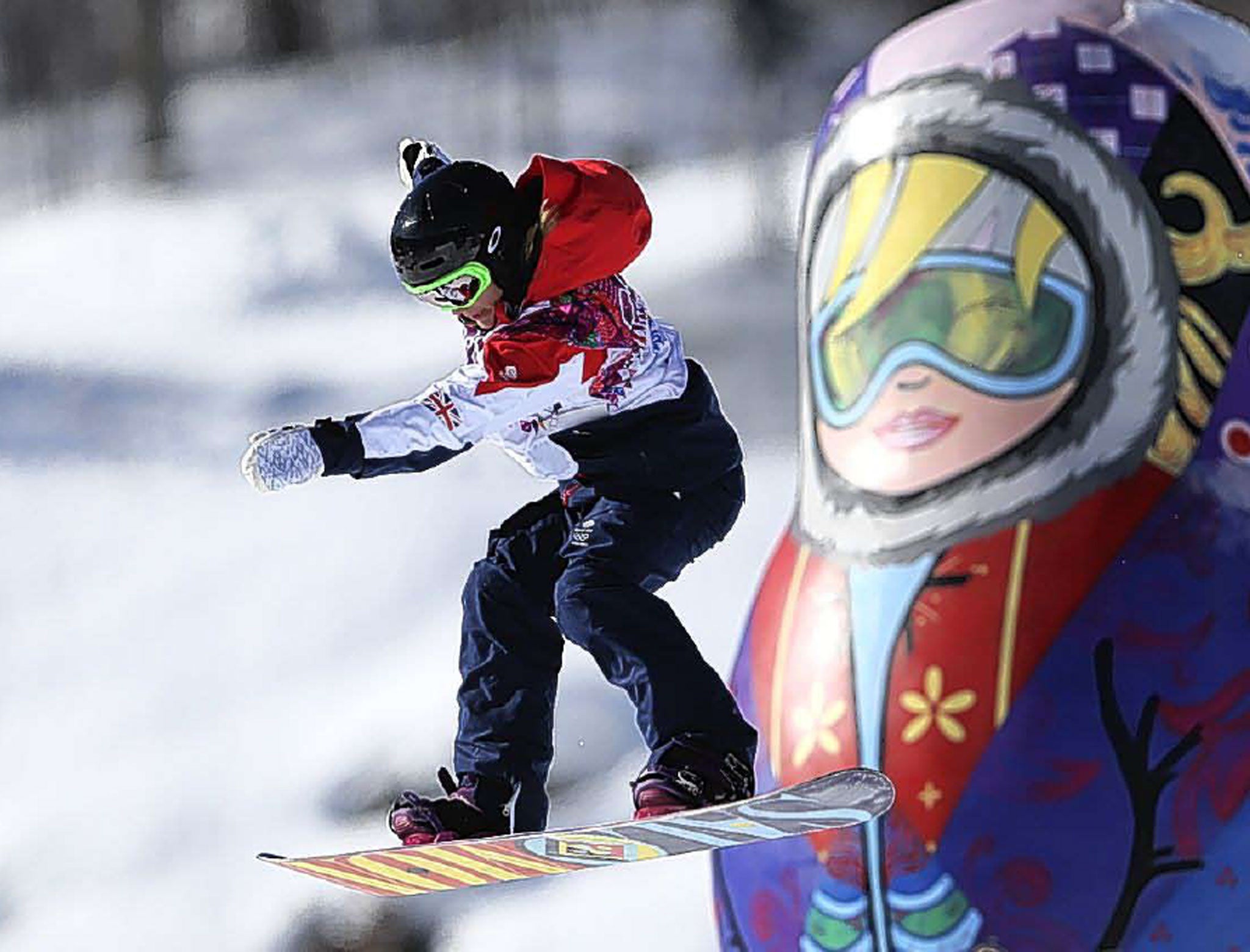 A competitor takes a jump past a giant matryoshka doll during a
snowboard slopestyle training session at the Rosa Khutor Extreme Park in Krasnaya