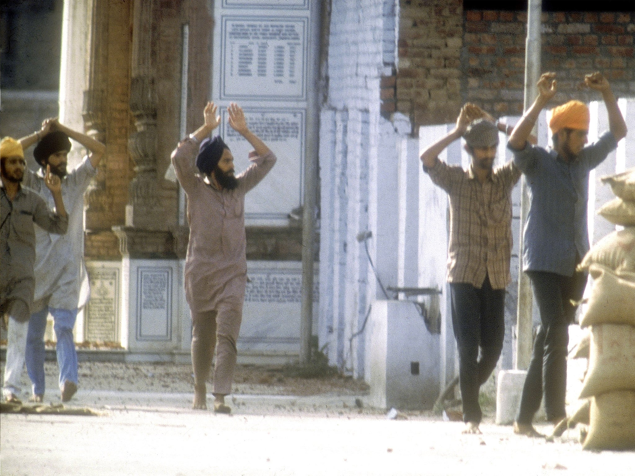 Suspected Sikh militants surrender to the army during the assault on the Golden Temple of Amritsar in 1984