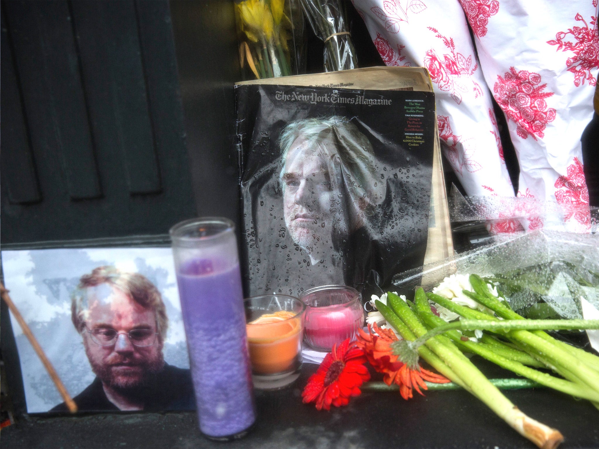 Candles, flowers and portraits sit outside the New York apartment of Phillip Seymour Hoffman