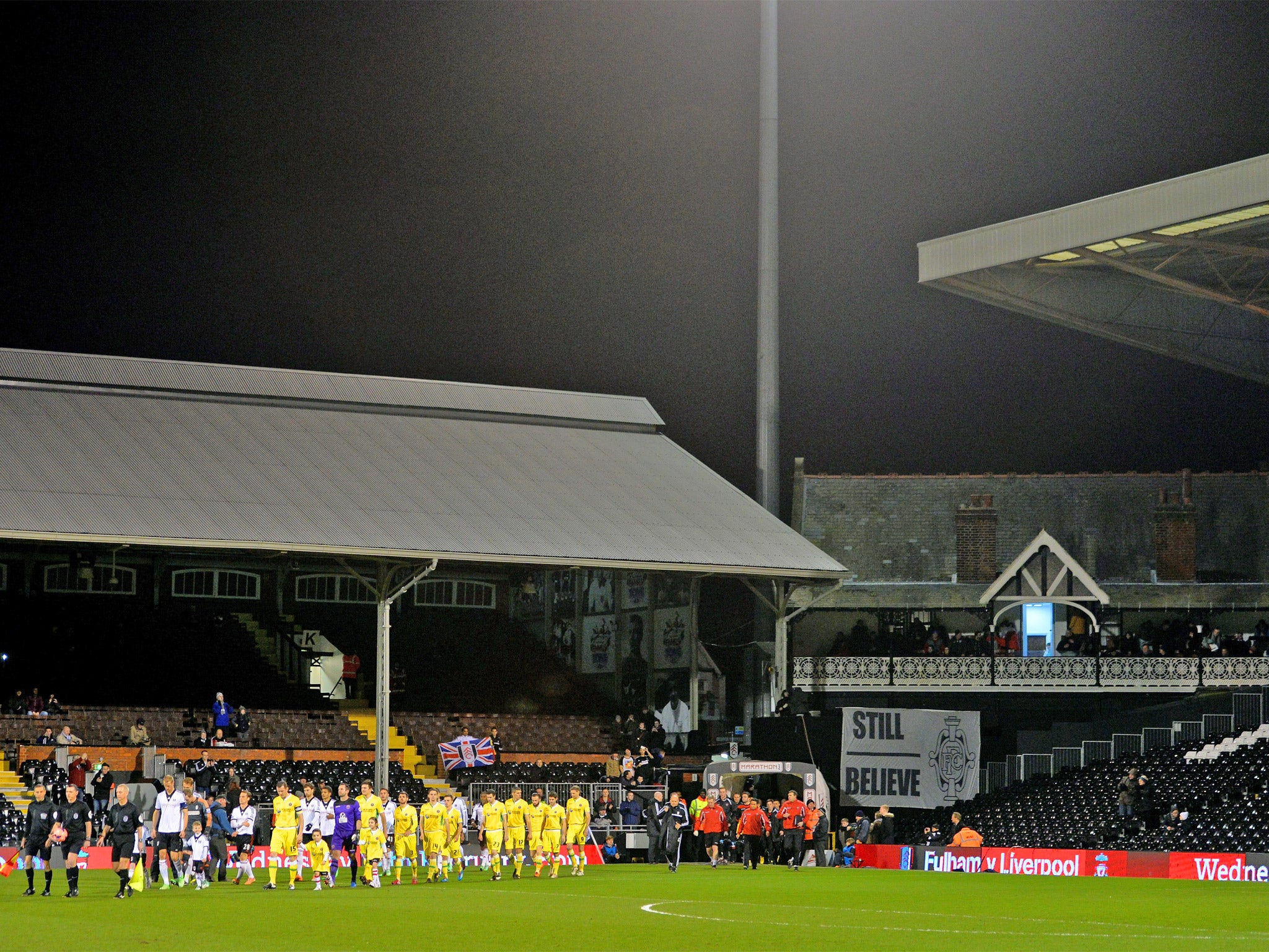 The two teams walk out to a near empty stadium
