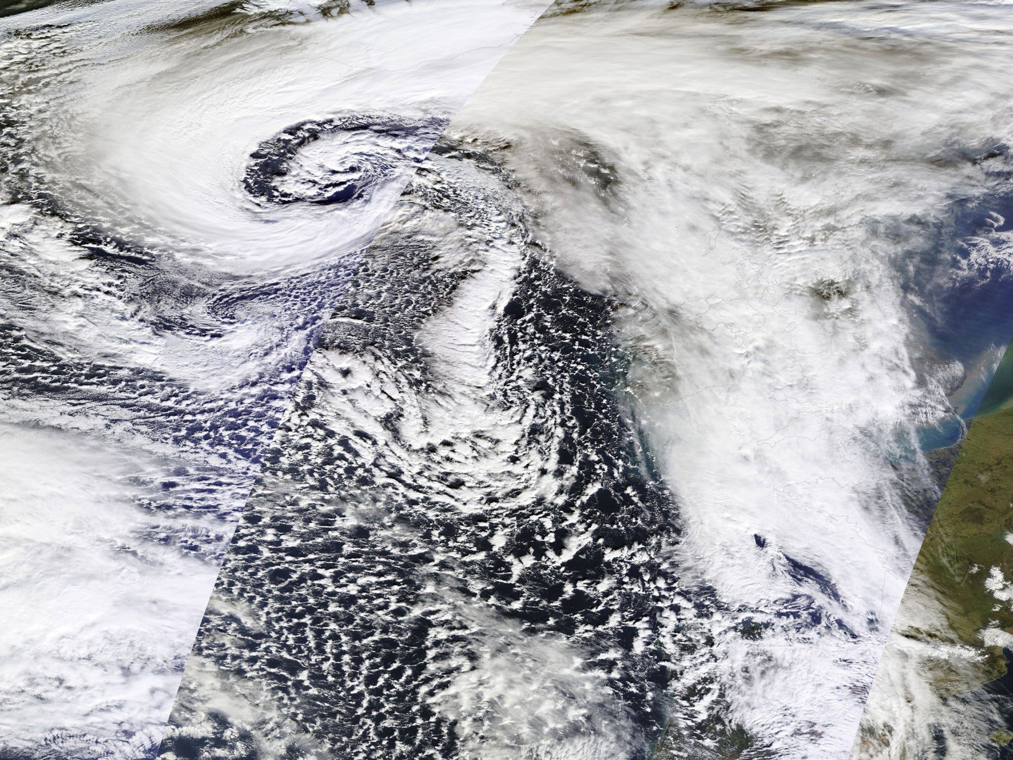 This composite satellite image of data from the NASA Terra and Aqua satellites shows the large storm system causing floods and high winds and tides in many western areas of the British Isles