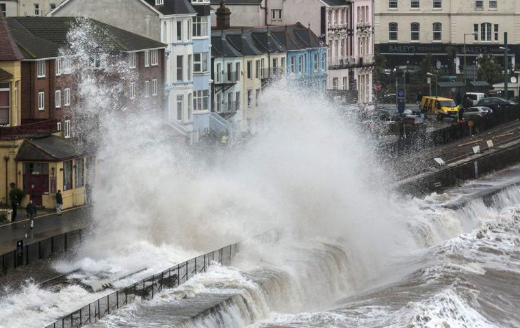 Waves crash against the seafront and railway line at Dawlish, Devon during the recent storms