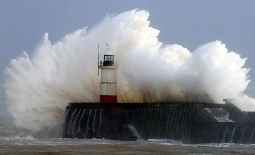 Waves crash over the harbour wall in Newhaven, Sussex