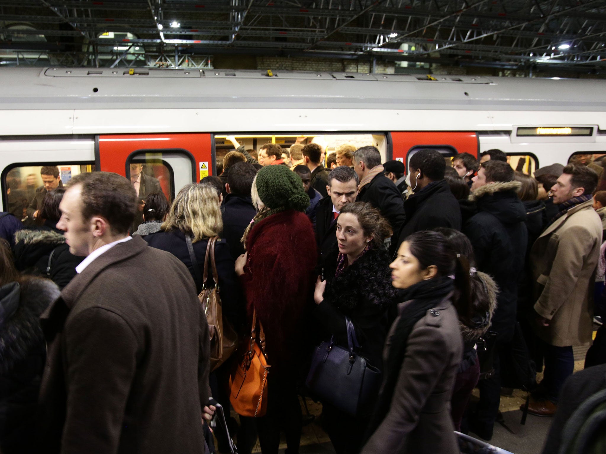 Commuters boarding a train at Farringdon Underground station