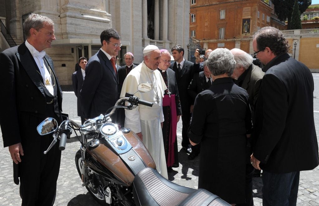 Pope Francis being presented with a Harley Davidson Dyna Super Glide motorcycle in Vatican City, the Vatican, 12 June 2013.