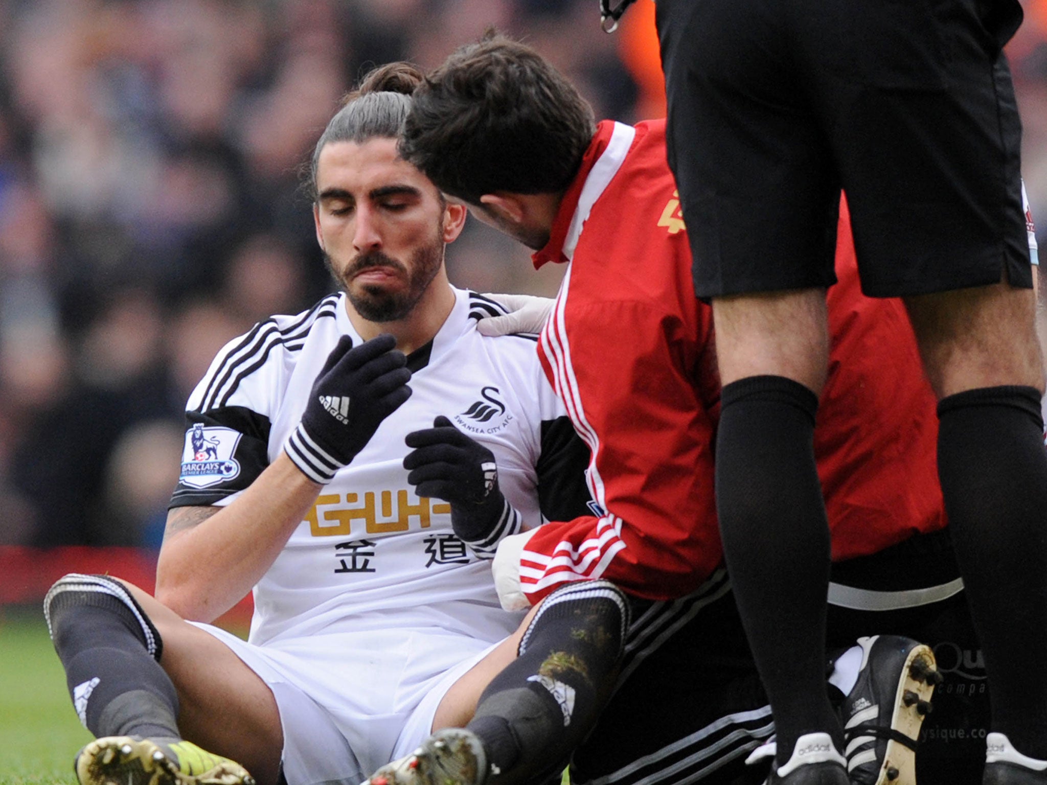 Chico receives treatment after being struck by Andy Carrol