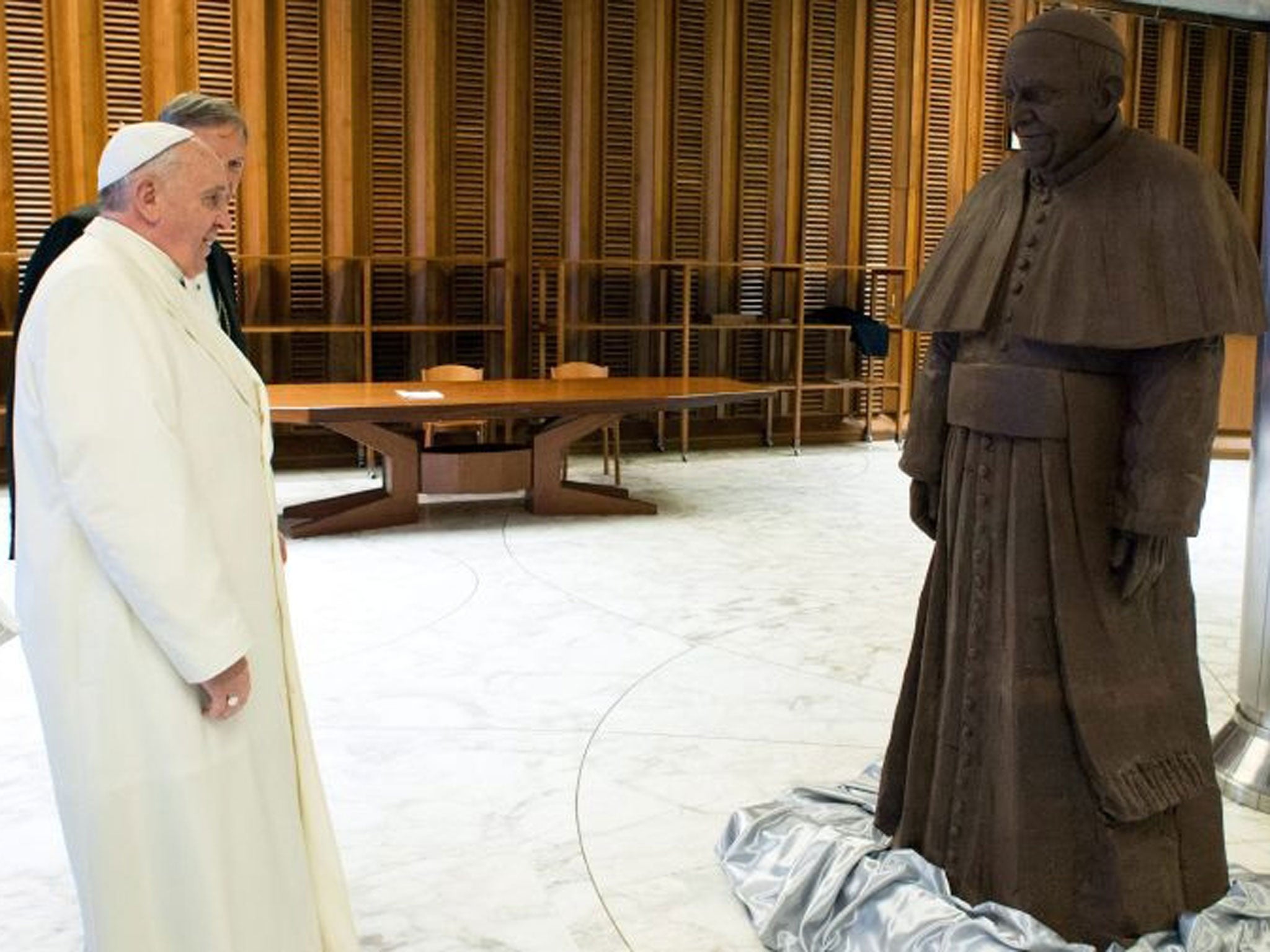 Pope Francis stands in front of a chocolate statue of him in Vatican City, Vatican, 05 February.