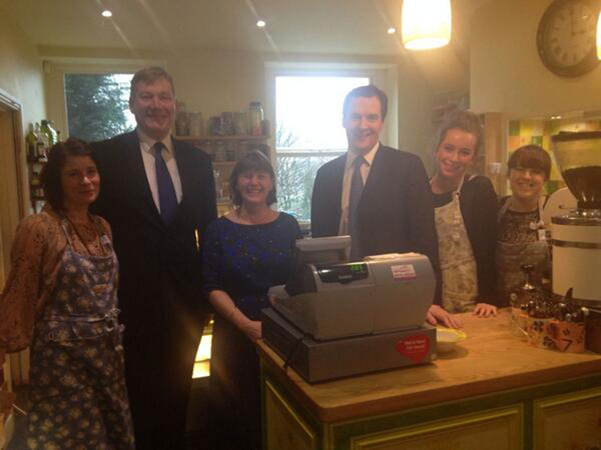 George Osborne poses with staff at from the Cobbles and Clay cafe in Haworth