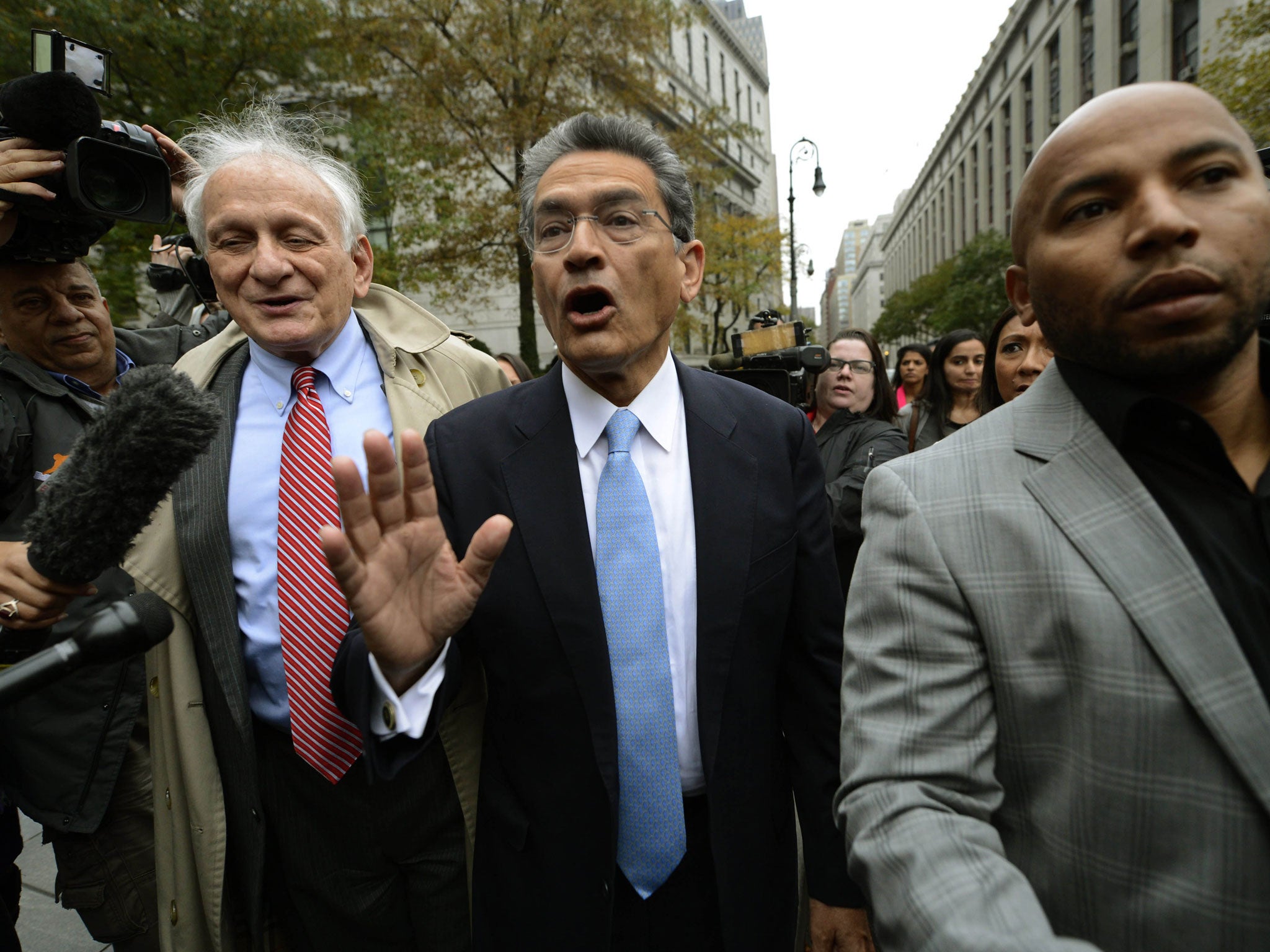 Rajat Gupta, centre, leaves court in New York after being sentenced for passing on secrets