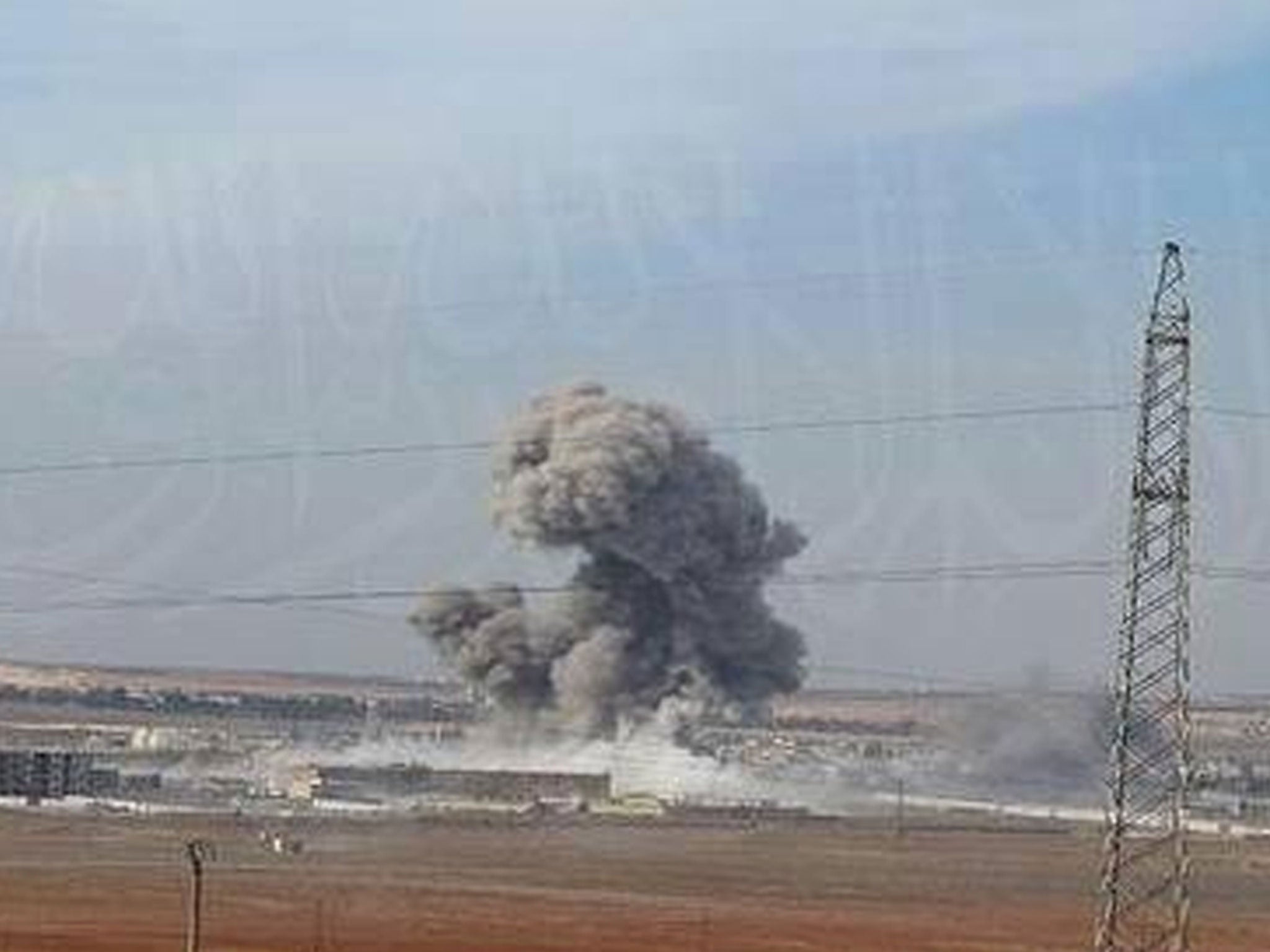 A photo showing a blast allegedly set off by a British suicide bomber at a prison in the Syrian city of Aleppo