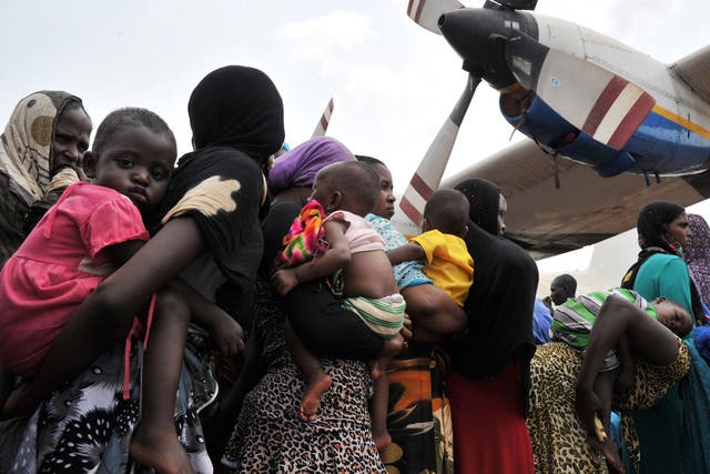 Chadian nationals and other Muslims queue at a Bangui military base for evacuation flights to Chad