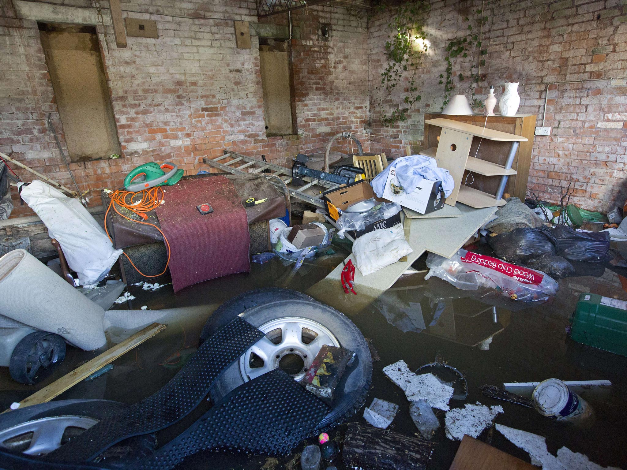 Belongings are seen, piled up in a outhouse which has been surrounded by flood water in Moorland
