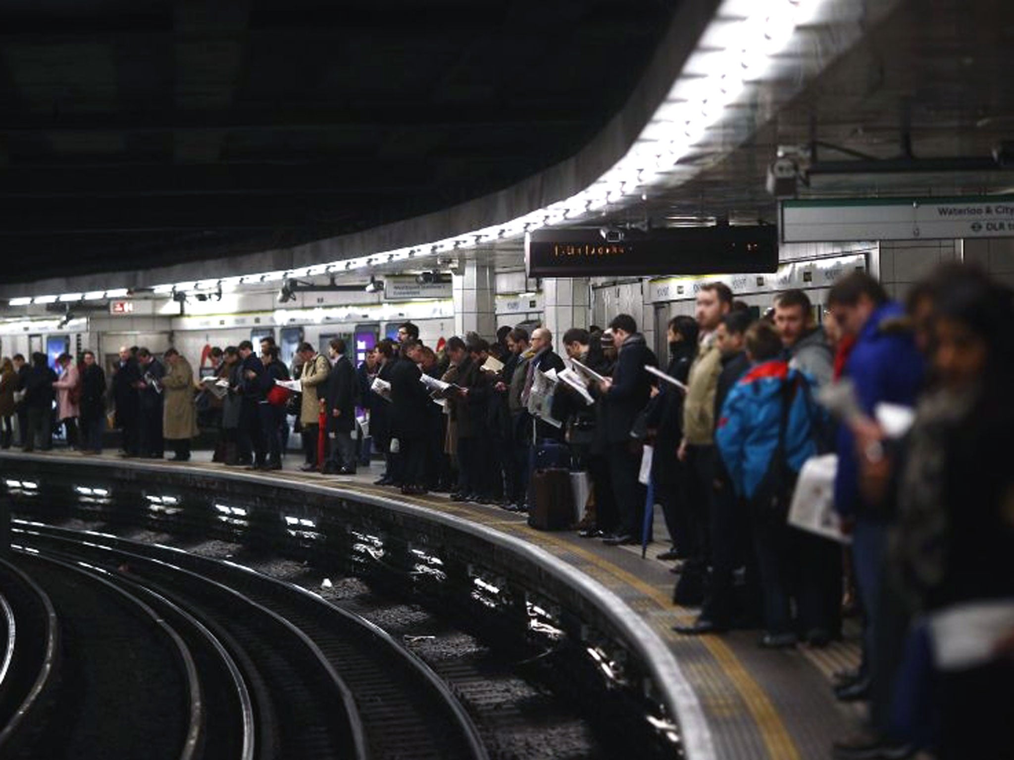 Commuters wait during the evening rush hour on the second day of a strike by London Underground workers in central London, 6 February.