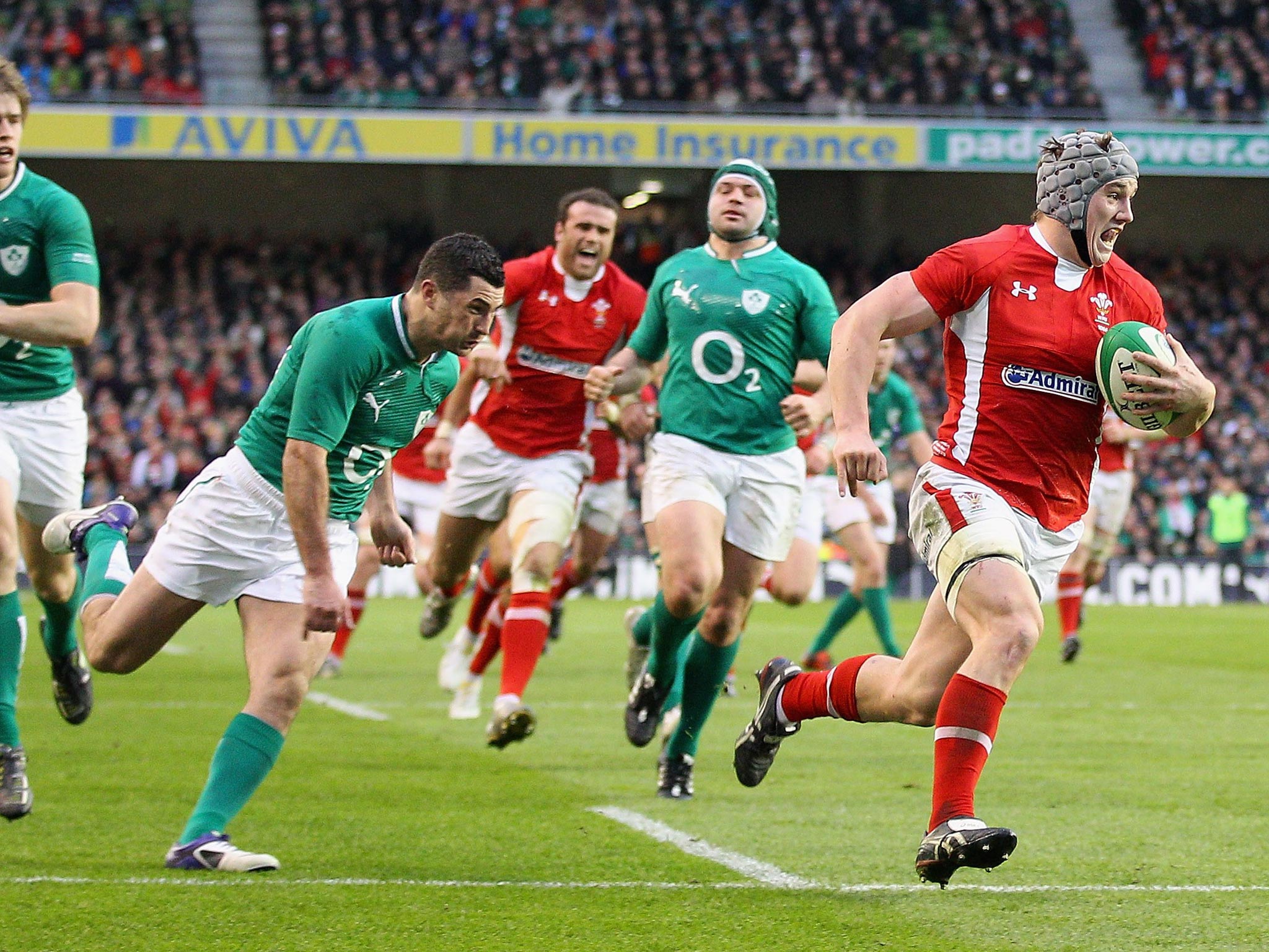 Jamie Roberts (third left) roaring Jonathan Davies on his way to a dramatic try against Ireland in Dublin in 2012