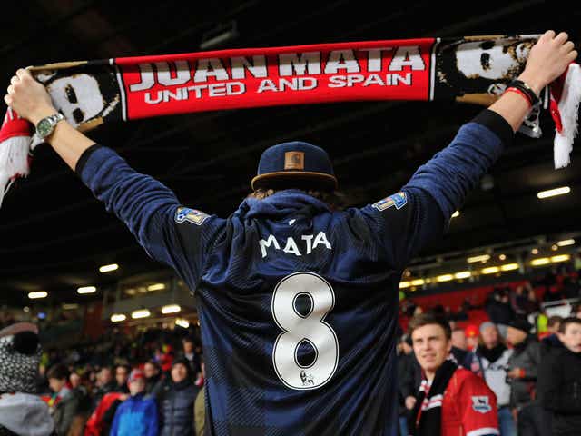 A Manchester United fan shows his support for Juan Mata