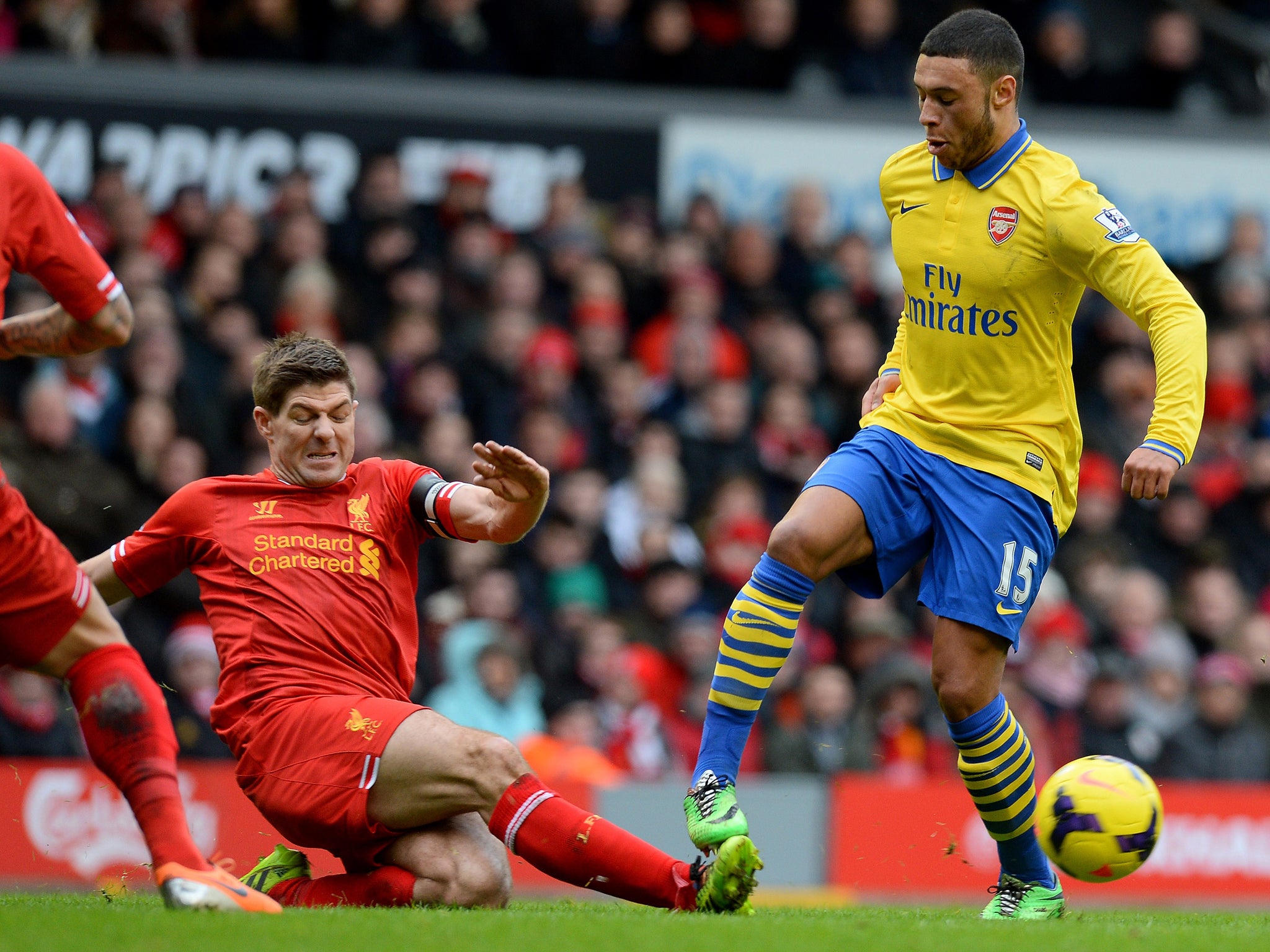Alex Oxlade-Chamberlain (right) is tackled by Steven Gerrard in Arsenal's 5-1 defeat by Liverpool on Saturday