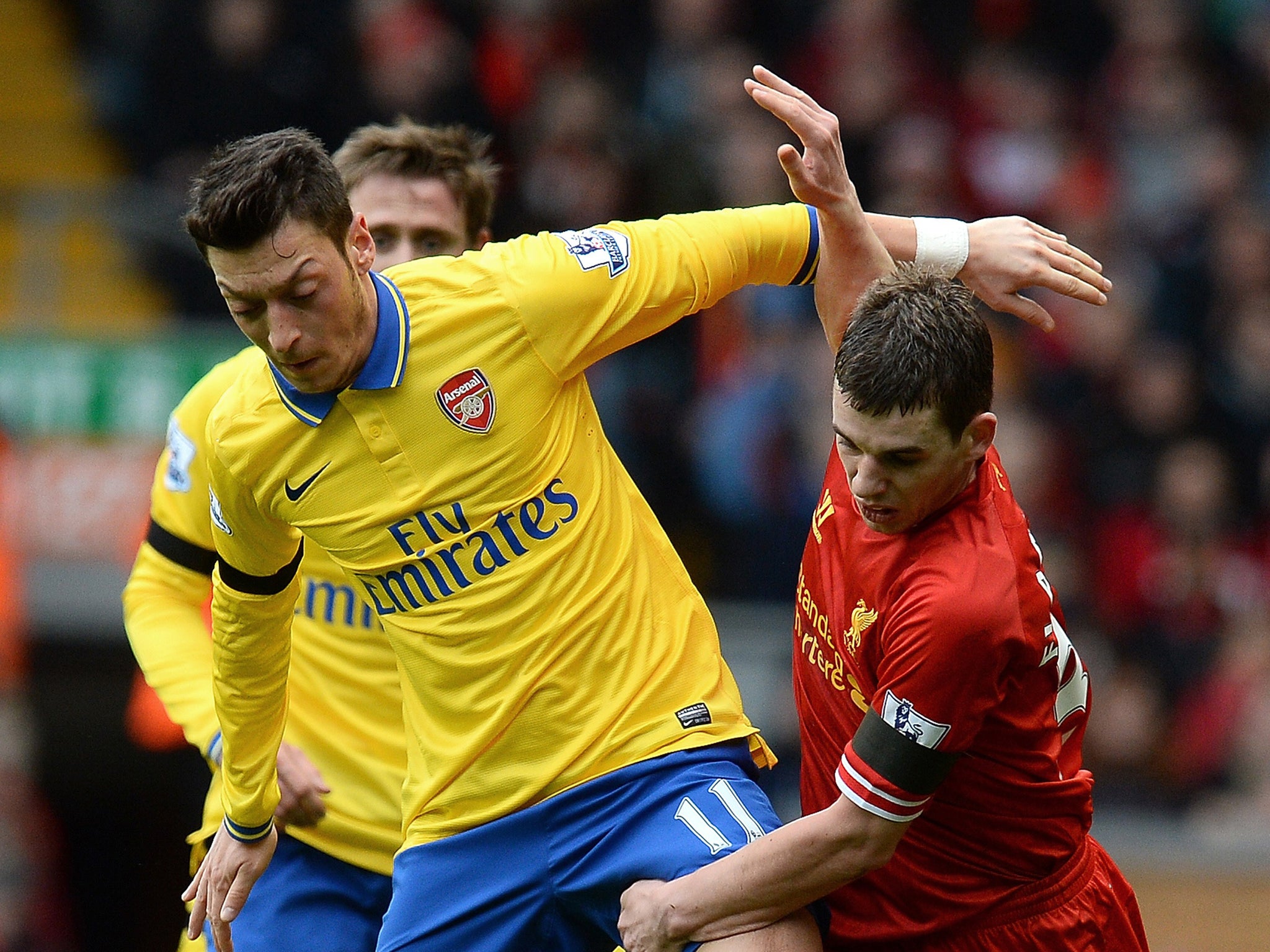 Ozil is hurried off the ball by Liverpool's Jon Flanagan