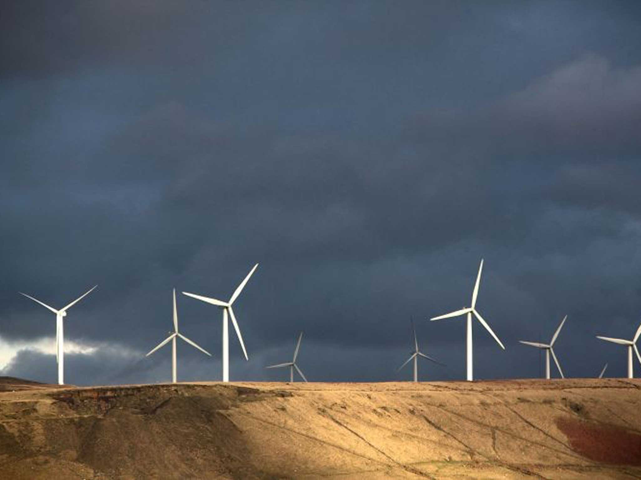 The turbine sails of the Scout Moor Wind Farm in the Pennines dominate the skyline