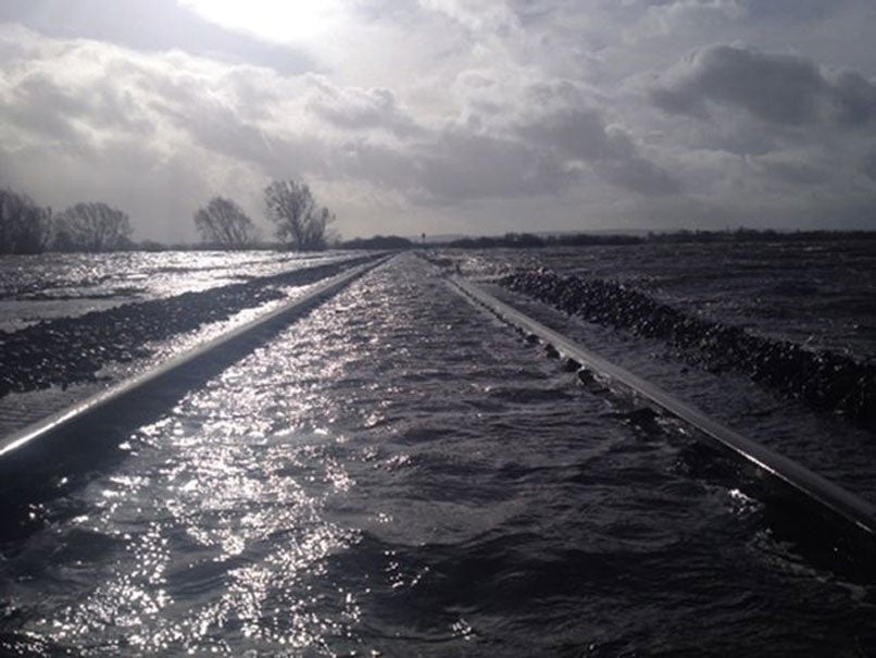 Rail services in and out of the West Country have been stopped after the River Perrett flooded on the Somerset Levels