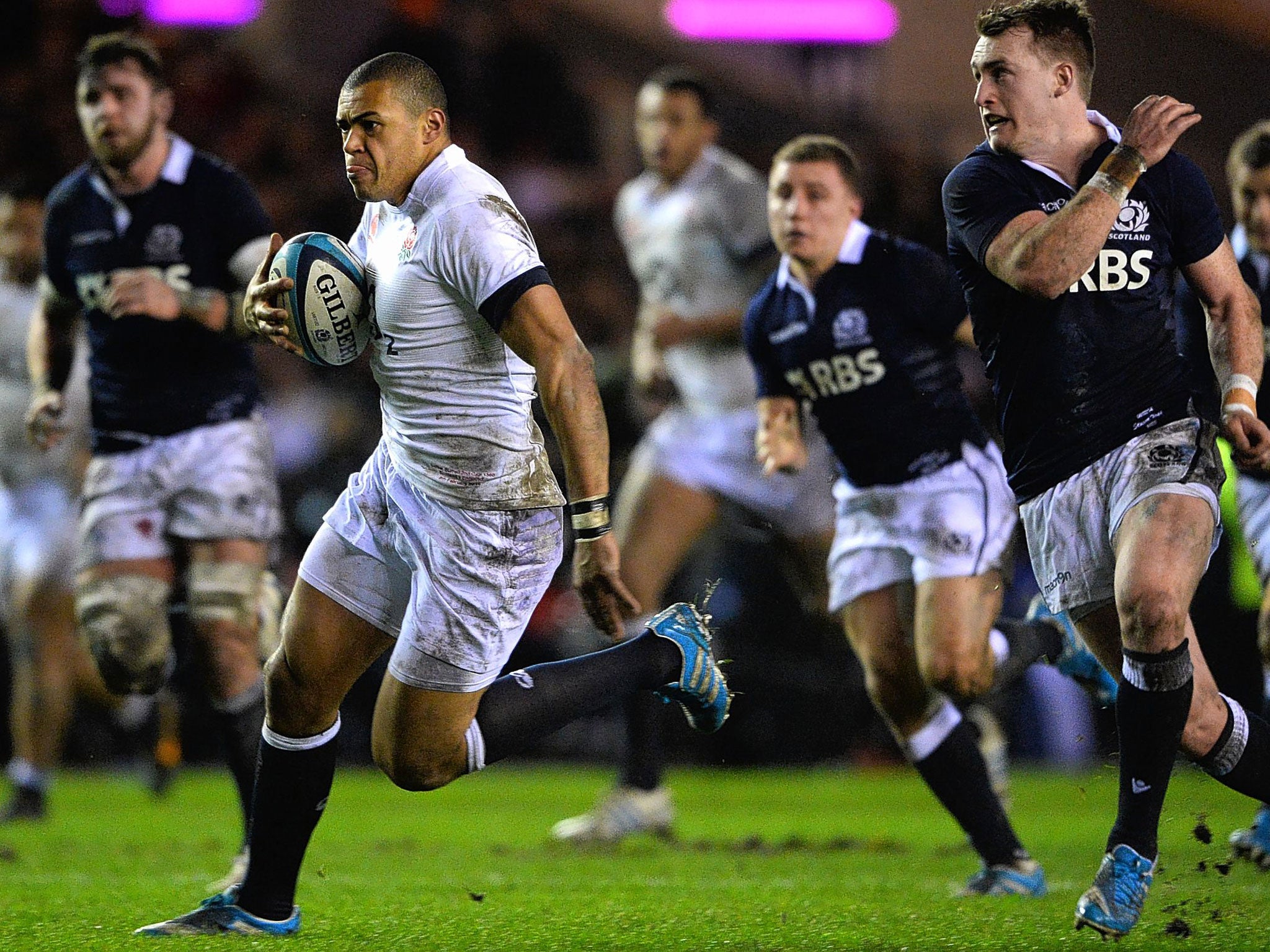 England’s Luther Burrell charges for the Scots line