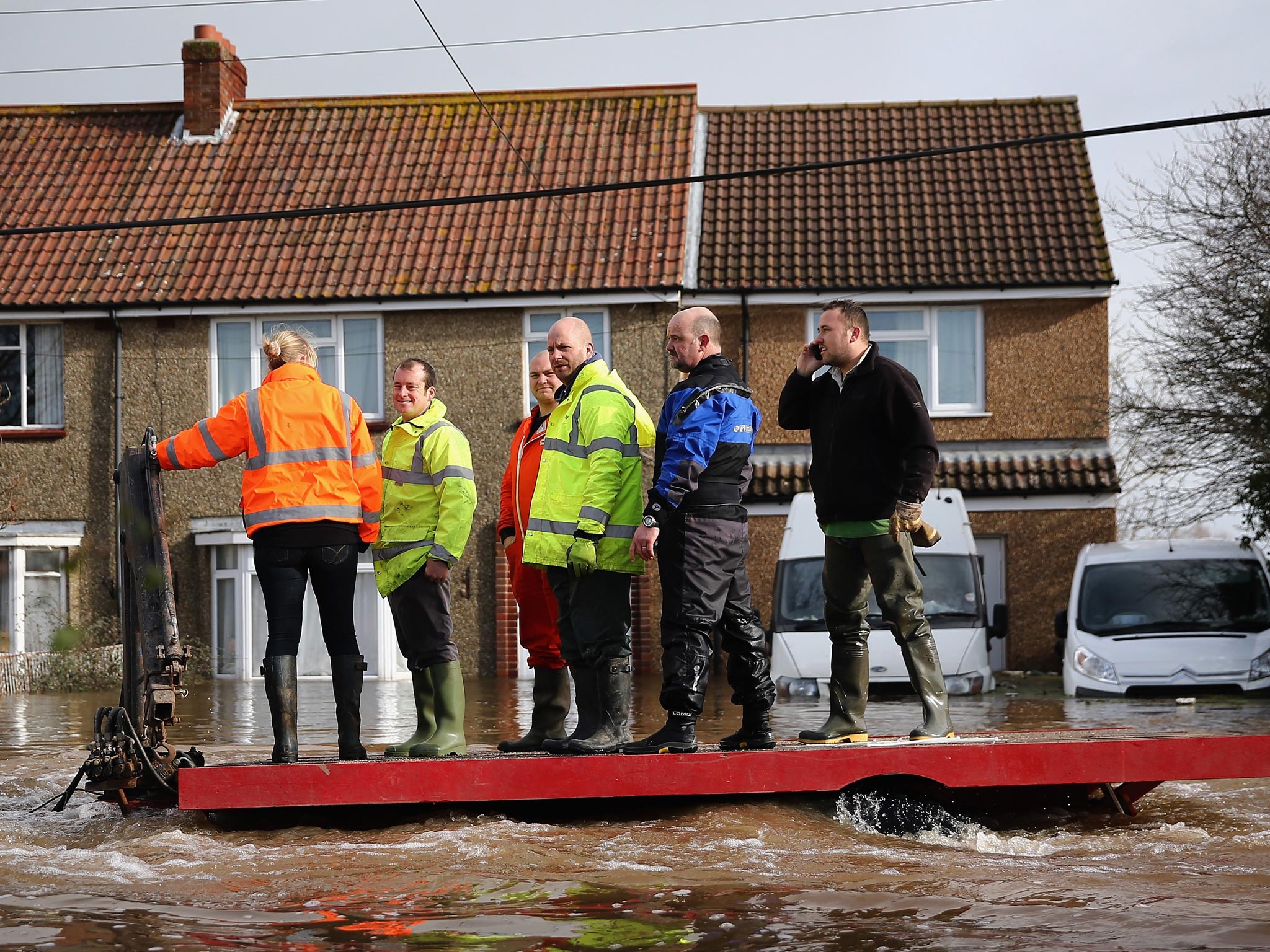 Residents are ferried through the flooded village of Moorland