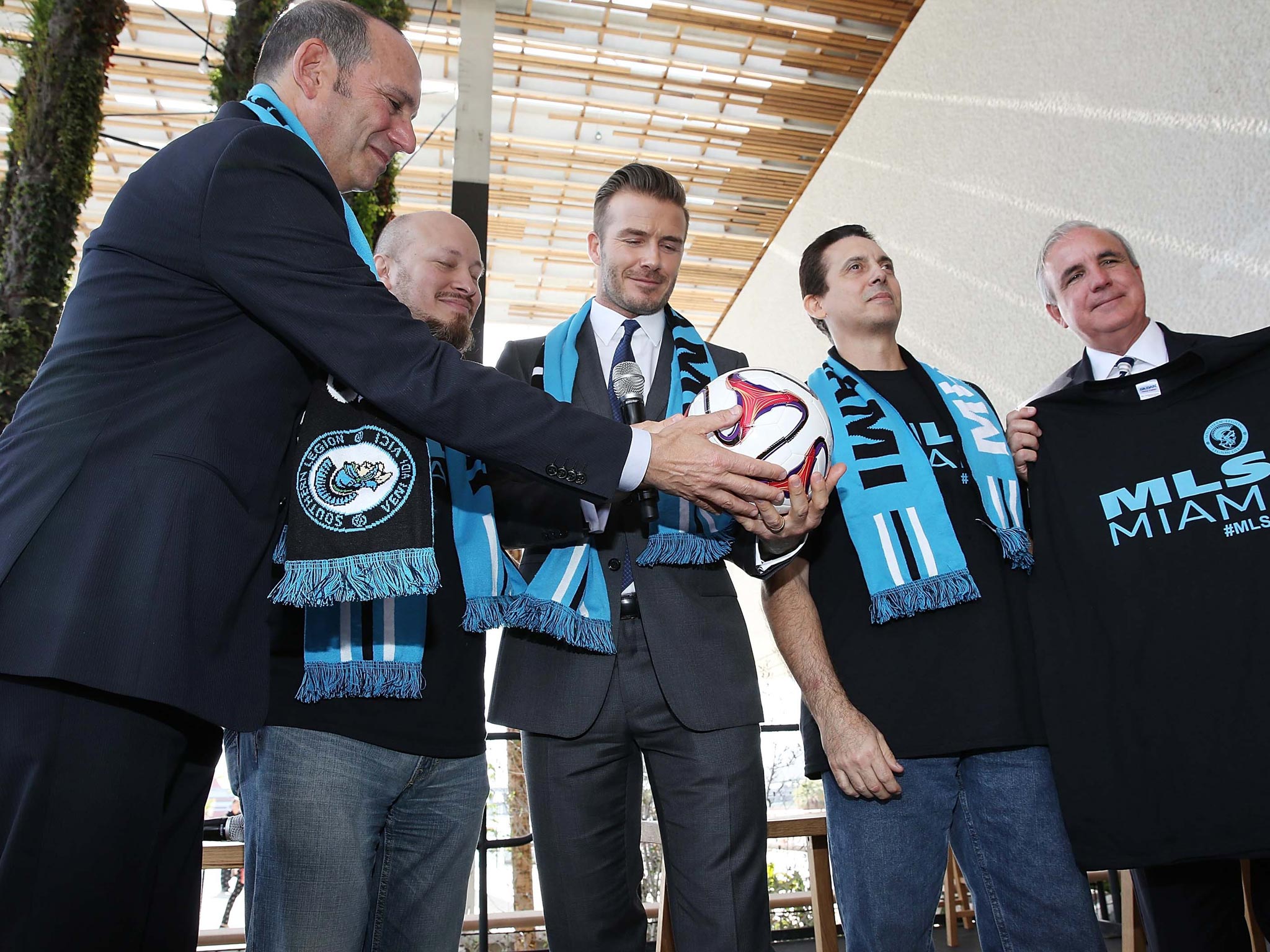 Beckham (centre) at his Miami press conference to launch plans for a new MLS franchise