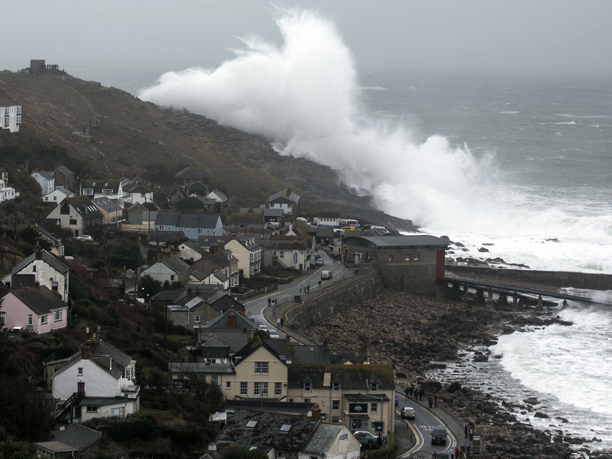 Storm waves break at Sennen on 8 February, 2014 in Cornwall, England. The Met Office's chief scientist has now warned that the "persistent" storms may be linked to climate change.